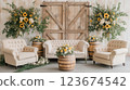 Elegant sofa and armchairs with sunflower arrangements in rustic barn setting for wedding or event 123674542