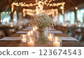 White flowers and candles decorating rustic wedding table 123674543