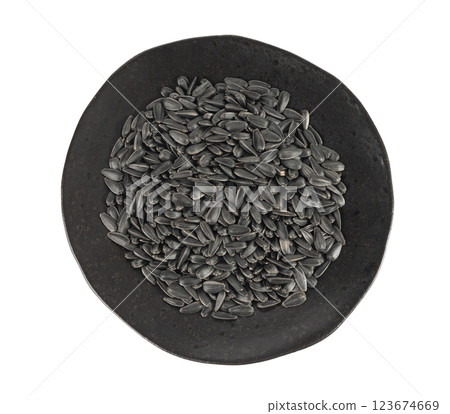 Sunflower seeds pile isolated, black oil sun flower grains group with shell, fresh edible oil seeds heap 123674669