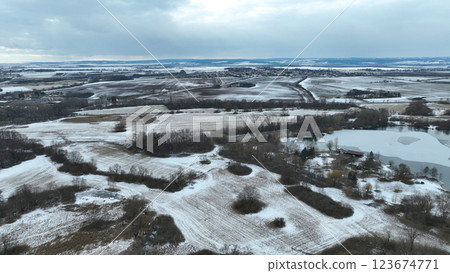 Meadow drone aerial winter landscape snow floodplain frost Plane loucky fog morning over nature snowy reserve, Litovelske Pomoravi icy protected landscape area, pond ice plants, willows, field Europe 123674771