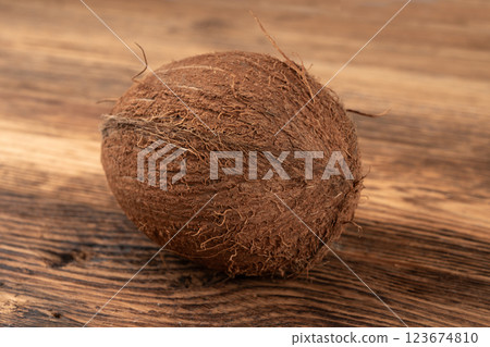 Whole coconut, one coco nut, single fresh tropical palm fruit, natural milk, oil ingredient 123674810