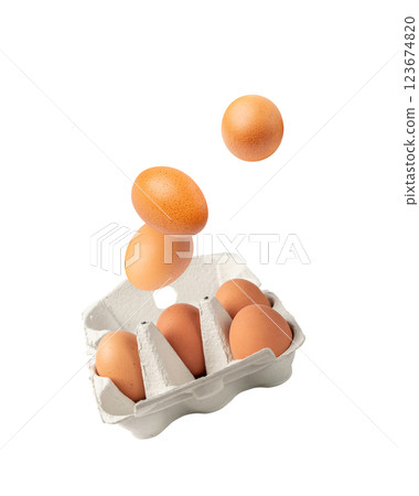 Open box with whole brown eggs falling isolated on white background, flying fresh organic Open box with whole brown eggs falling isolated on white background, flying fresh organic 123674820