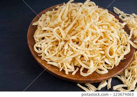 Passatelli spatzle pasta in bowl, raw spaetzle noodles, dry homemade german macaroni Passatelli spatzle pasta in bowl, raw spaetzle noodles, dry homemade german macaroni 123674863