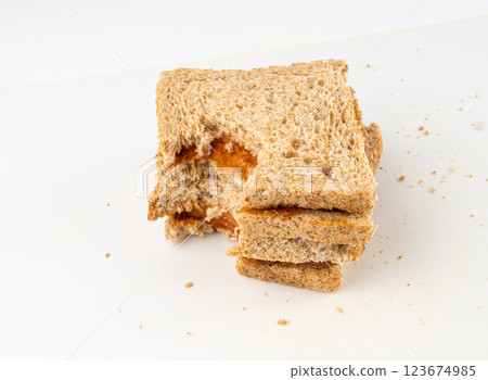 Bitten dried pate sandwich isolated, low-quality food leftovers, bad quality toast bread lunch Bitten dried pate sandwich isolated, low-quality food leftovers, bad quality toast bread lunch 123674985