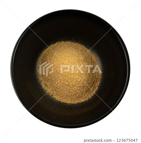 Ground fenugreek seeds in black bowl, milled dry trigonella powder, spicy methi dana pounded 123675047