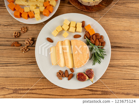 Cheese plate of color cheeses variety, yellow, white and blue cheese board, assorted dairy products Cheese plate of color cheeses variety, yellow, white and blue cheese board, assorted dairy products 123675124