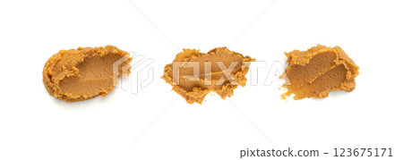 Miso paste isolated. Japanese shiro miso seasoning sauce, fermented soybean spread, brown soy cream Miso paste isolated. Japanese shiro miso seasoning sauce, fermented soybean spread, brown soy cream 123675171