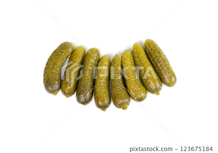 Gherkins isolated, pickled small cucumbers, tiny fermented food, little marinated canned vegetables Gherkins isolated, pickled small cucumbers, tiny fermented food, little marinated canned vegetables 123675184