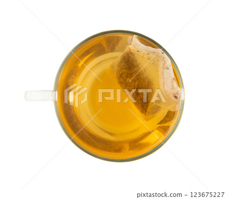 Herbal tea sachet in cup, hot water with chamomile and Hypericum or St. John's wort teabag Herbal tea sachet in cup, hot water with chamomile and Hypericum or St. John's wort teabag 123675227