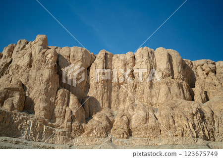 Yellow rocks near the walls of the temple of Hatshepsut on a blue background 123675749