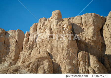 Yellow rocks near the walls of the ancient temple of Hatshepsut 123675750