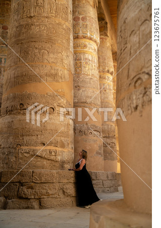 Girl standing with columns in ancient cornac Girl standing with columns in ancient cornac 123675761