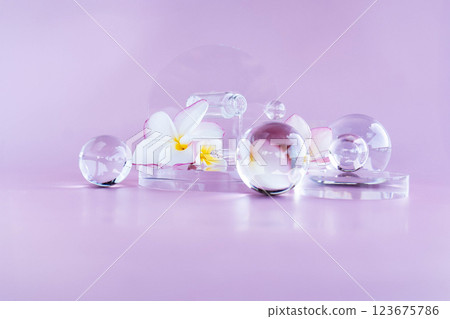 Artful glass spheres and flowers on a pastel backdrop highlight spa products. Artful glass spheres and flowers on a pastel backdrop highlight spa products. 123675786