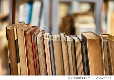 Many book shelves in a library 123676544