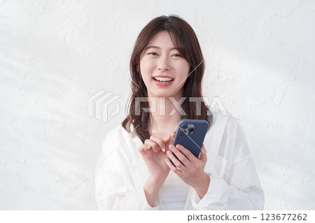 A young woman using a smartphone 123677262