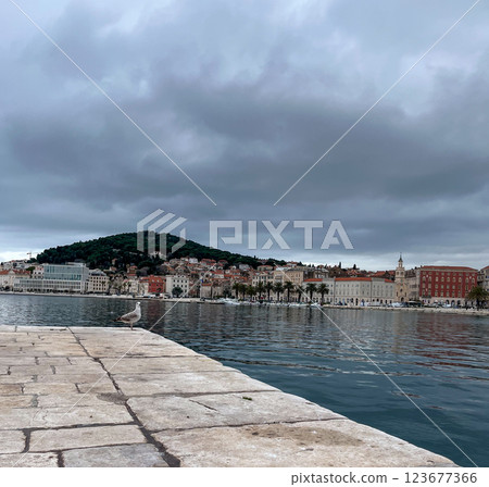 Split pier overlooking the old town and promenade on a cloudy day. Split pier overlooking the old town and promenade on a cloudy day. 123677366