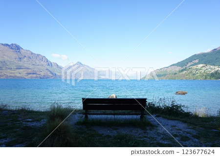 A bench overlooking Lake Wakatipu in Queenstown, New Zealand A bench overlooking Lake Wakatipu in Queenstown, New Zealand 123677624