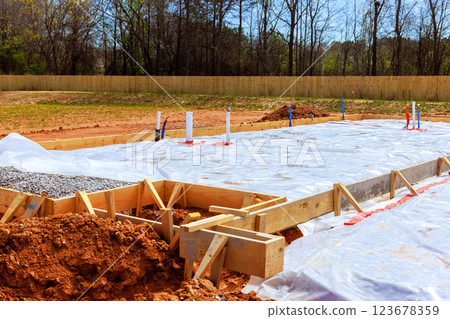 Construction new residential foundation with protective plastic insulation prevent moisture indicating progress on construction site Construction new residential foundation with protective plastic insulation prevent moisture indicating progress on construction site 123678359