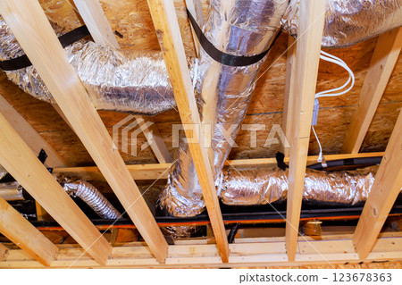 Ducts are being installed in ceiling structure of new building under construction, during ventilation work. Ducts are being installed in ceiling structure of new building under construction, during ventilation work. 123678363