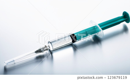 syringe, A medical syringe with a needle, filled with liquid, placed on a reflective surface with a white background syringe, A medical syringe with a needle, filled with liquid, placed on a reflective surface with a white background 123679119