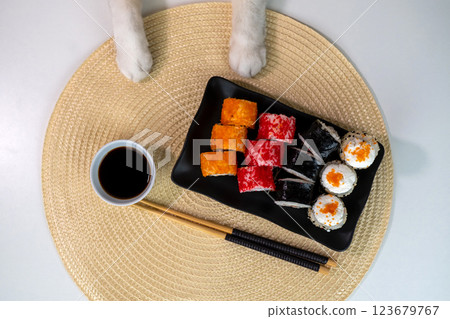 Sushi platter with rice paper rolls and soy sauce dish on woven mat Sushi platter with rice paper rolls and soy sauce dish on woven mat 123679767