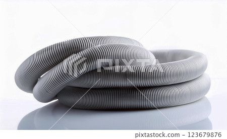 a coiled air conditioning pipe with a ribbed metallic texture, placed on a white reflective surface, industrial design and flexibility of the pipe, making it suitable for HVAC systems, ventilation 123679876
