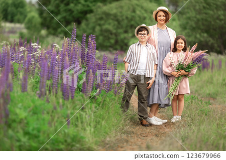 Caucasian family enjoying nature walk in lupine field Caucasian family enjoying nature walk in lupine field 123679966