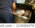 A person who prepares fish at a fishing spot 123680478