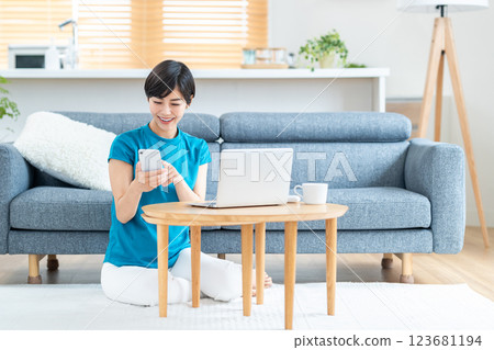 A woman working from home in the living room. A woman working from home in the living room. 123681194