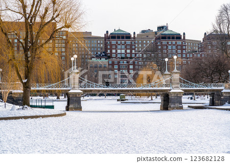 Public garden foot bridge above the lake in Public Garden Park in Boston, MA covered with winter snow Public garden foot bridge above the lake in Public Garden Park in Boston, MA covered with winter snow 123682128