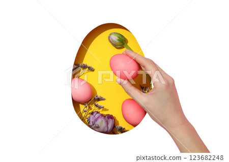 PNG, Easter, cut out egg with flowers, on a yellow background, with a hand and pink eggs isolated on a white background 123682248