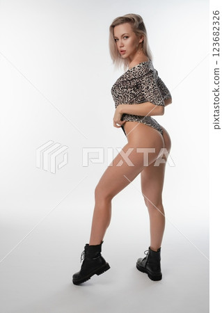 Sporty woman showcasing beauty in stylish lingerie during a photo session 123682326