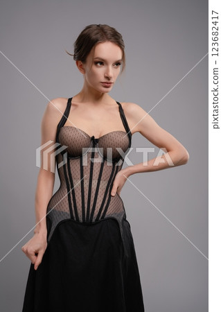 Stunning woman in elegant corset lingerie showcasing modern fashion trends Stunning woman in elegant corset lingerie showcasing modern fashion trends 123682417