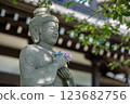 Buddha statue holding hydrangea 123682756