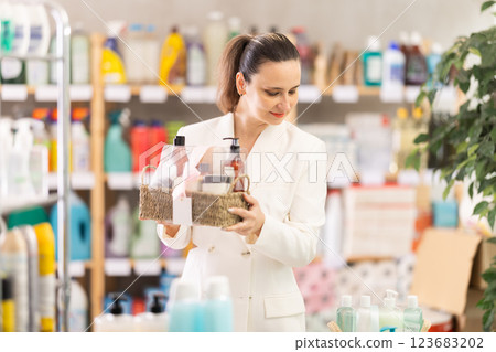 Adult woman buyer chooses cosmetics gift set 123683202