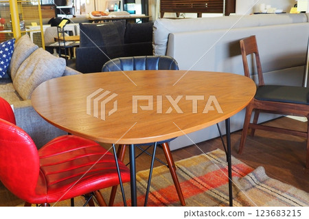 A triangular table and red and blue leather chairs on display at an interior design shop A triangular table and red and blue leather chairs on display at an interior design shop 123683215