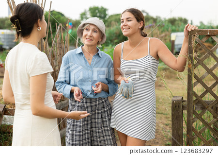 3 females talking at garden 3 females talking at garden 123683297