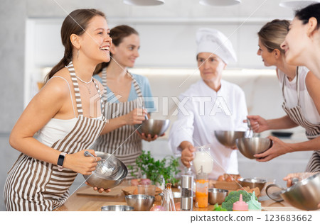 Young woman learning to cook and chatting at master class Young woman learning to cook and chatting at master class 123683662