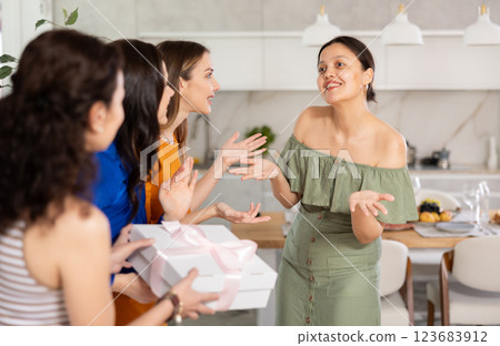 Happy women greeting each other before starting house party 123683912