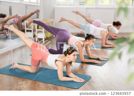 Young woman exercising with pilates loop Young woman exercising with pilates loop 123683937