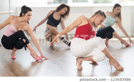 Woman performing high heels choreography during group class Woman performing high heels choreography during group class 123683986