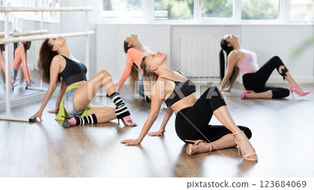 Female dancer mastering floorwork during high heels dance routine Female dancer mastering floorwork during high heels dance routine 123684069