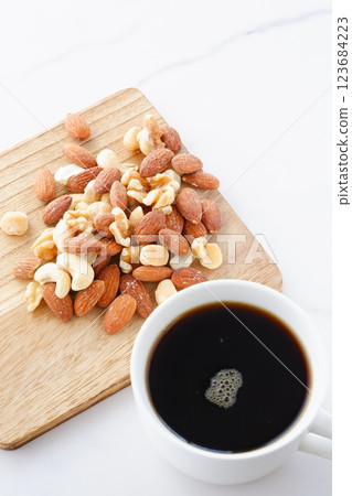 Mixed nuts (almonds, walnuts, cashews, macadamia nuts) and freshly brewed coffee Mixed nuts (almonds, walnuts, cashews, macadamia nuts) and freshly brewed coffee 123684223