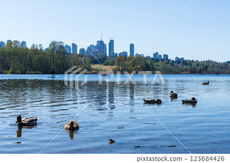 Deer Lake Park lakeshore. Metrotown modern buildings skyline in the background. Burnaby, BC, Canada. 123684426