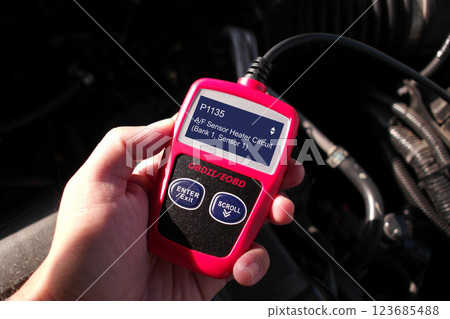 OBD or OBD-II scanner in use by technician for scanning fault code 123685488