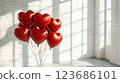 Close-up of many red heart-Close-up of many red heart-shaped balloons against a backdrop of a home interior. Valentine's Day concept 123686101