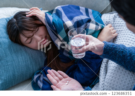 A woman who has caught a cold and is being nursed A woman who has caught a cold and is being nursed 123686351
