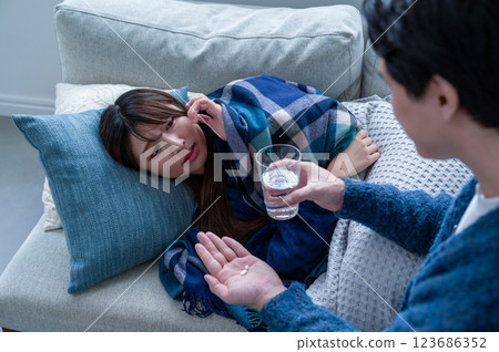 A woman who has caught a cold and is being nursed A woman who has caught a cold and is being nursed 123686352