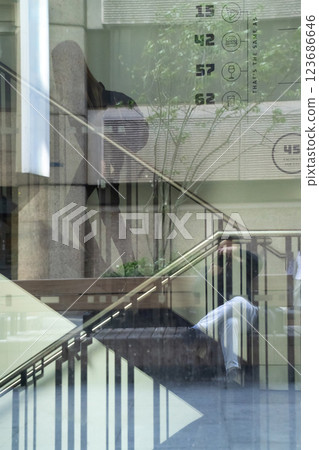 A contemporary glass structure refracts the energy of urban surroundings, blending architecture and daily life in a unique visual display. A contemporary glass structure refracts the energy of urban surroundings, blending architecture and daily life in a unique visual display. 123686646