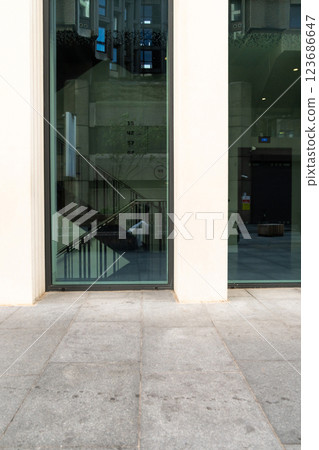 A contemporary glass structure refracts the energy of urban surroundings, blending architecture and daily life in a unique visual display. 123686647